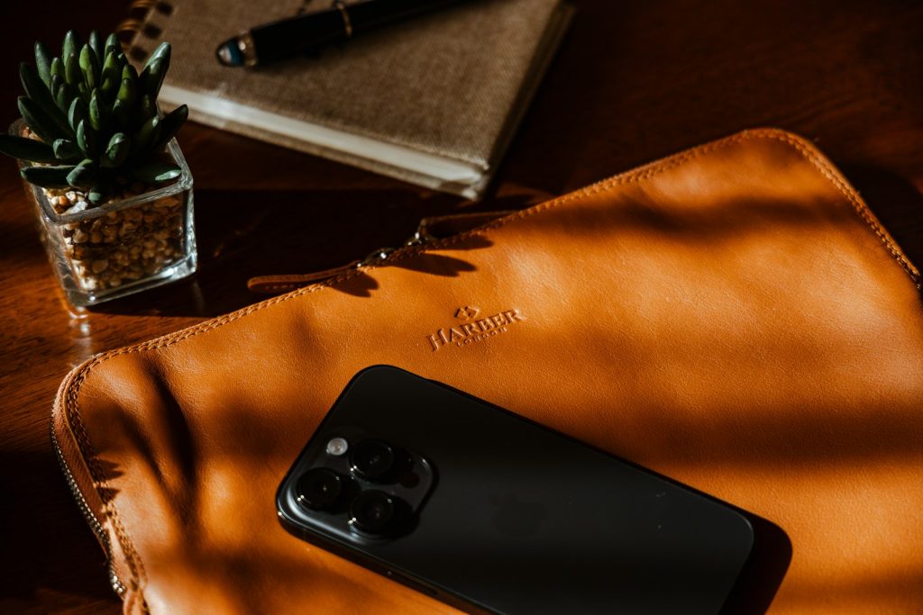 a cell phone sitting on top of a brown bag